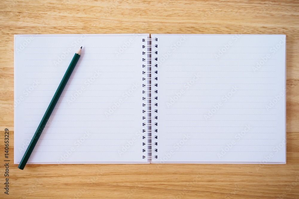 notebook top view with pencil on brown wood desk notebook top view with pencil on brown wood desk