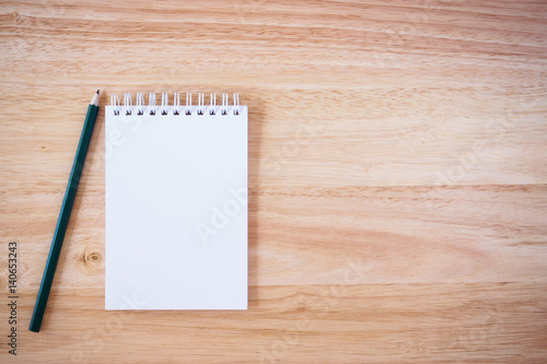 Pencil and Notepad on the wooden desk