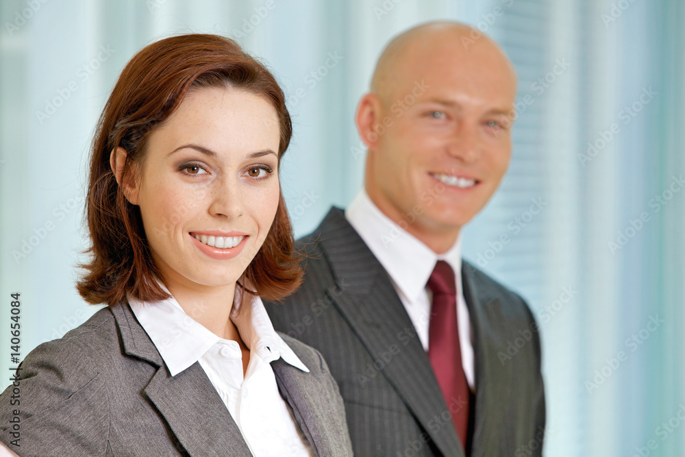 Portrait of young caucasian businessman and businesswoman in office Portrait of young caucasian businessman and businesswoman in office