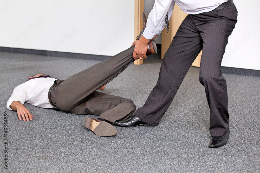 Businessmen pulling colleague's leg at office - obrazy, fototapety, plakaty 