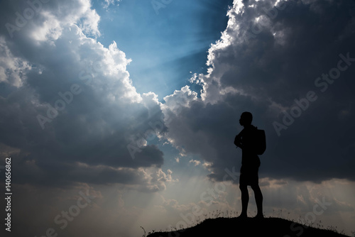 Silhouette of man and sky with sunlight © stcom