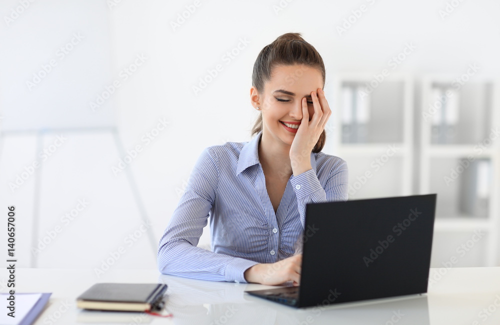 Surprised laughing business woman withvlaptop in the office Surprised laughing business woman withvlaptop in the office
