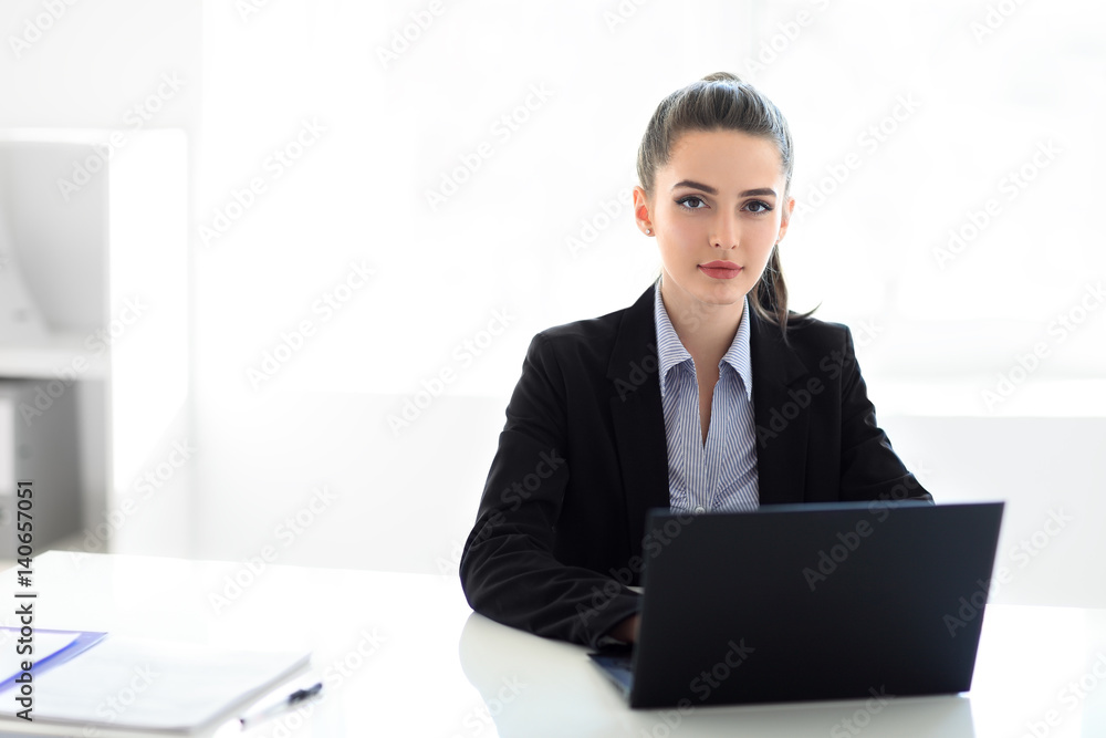 Young beautiful business woman with laptop in the office Young beautiful business woman with laptop in the office
