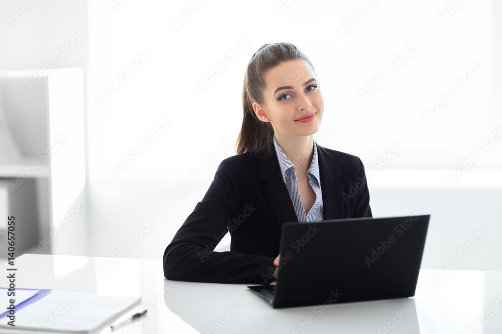 Portrait of beautiful business woman with laptop in the office