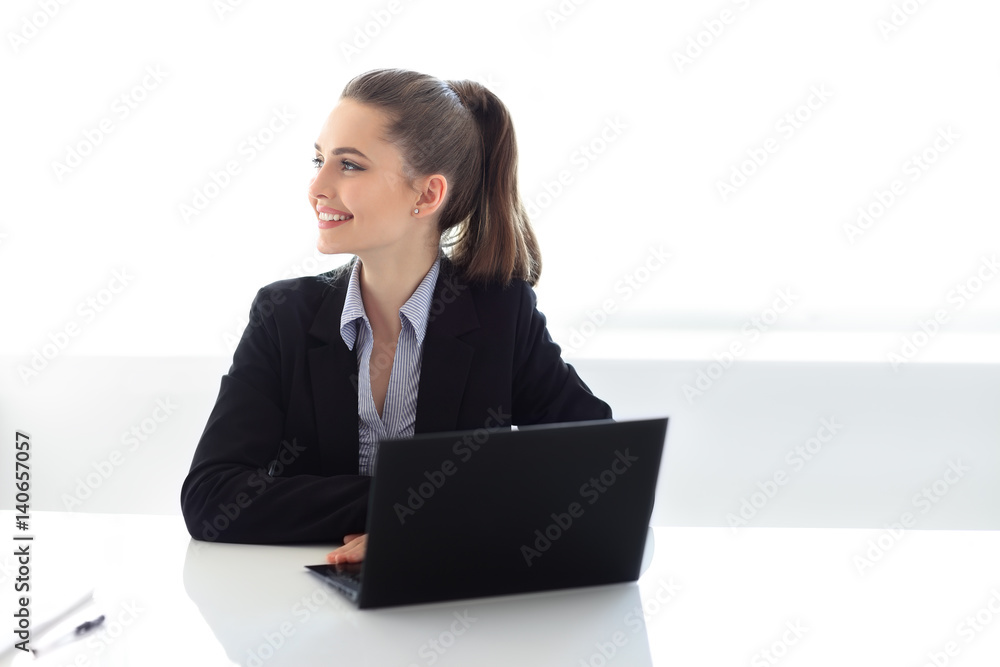 Portrait of smiling business woman with laptop in the office Portrait of smiling business woman with laptop in the office