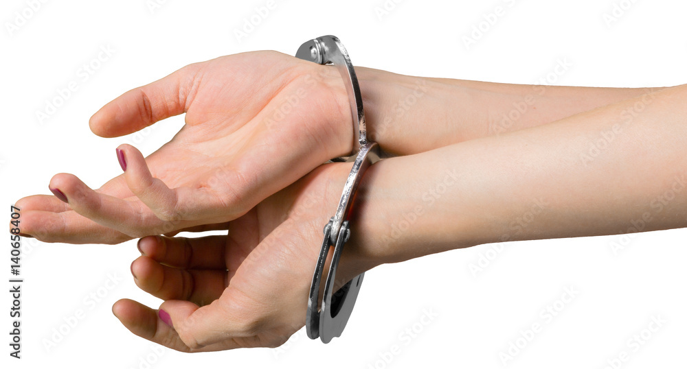 hand wearing handcuffs isolated on white background hand wearing handcuffs isolated on white background