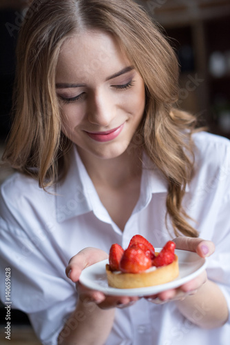 Woman with strawberry cake
