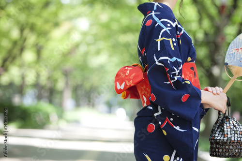 Midsection of young woman wearing Yukata