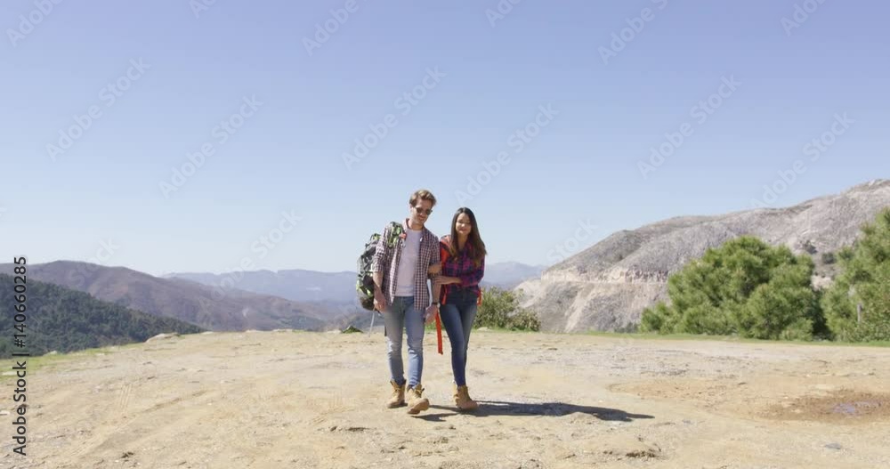 Romantic couple walking on plat of mountain and talking with amazing view on background in summer. Romantic couple walking on plat of mountain and talking with amazing view on background in summer.