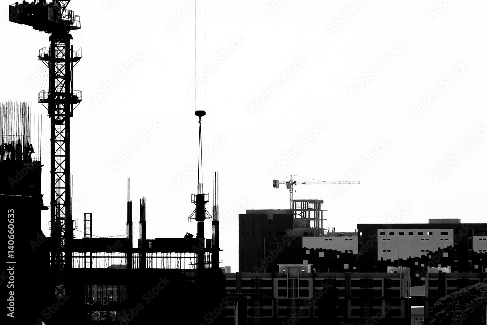 Construction site with cranes on silhouette background Construction site with cranes on silhouette background