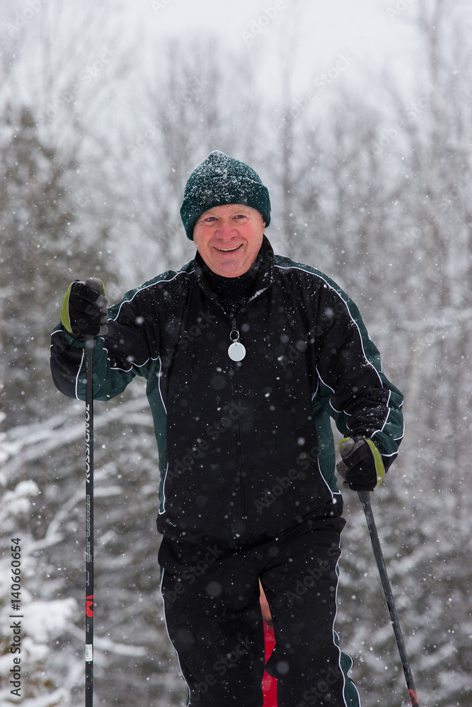 senior in winter on snow with skis cross-country skiing