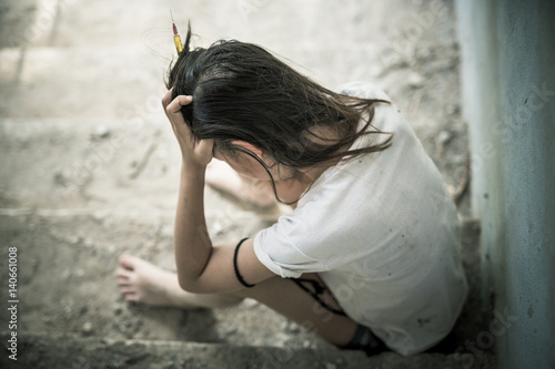 Fotografía Drug addict young woman with syringe in action, Drug abuse concept