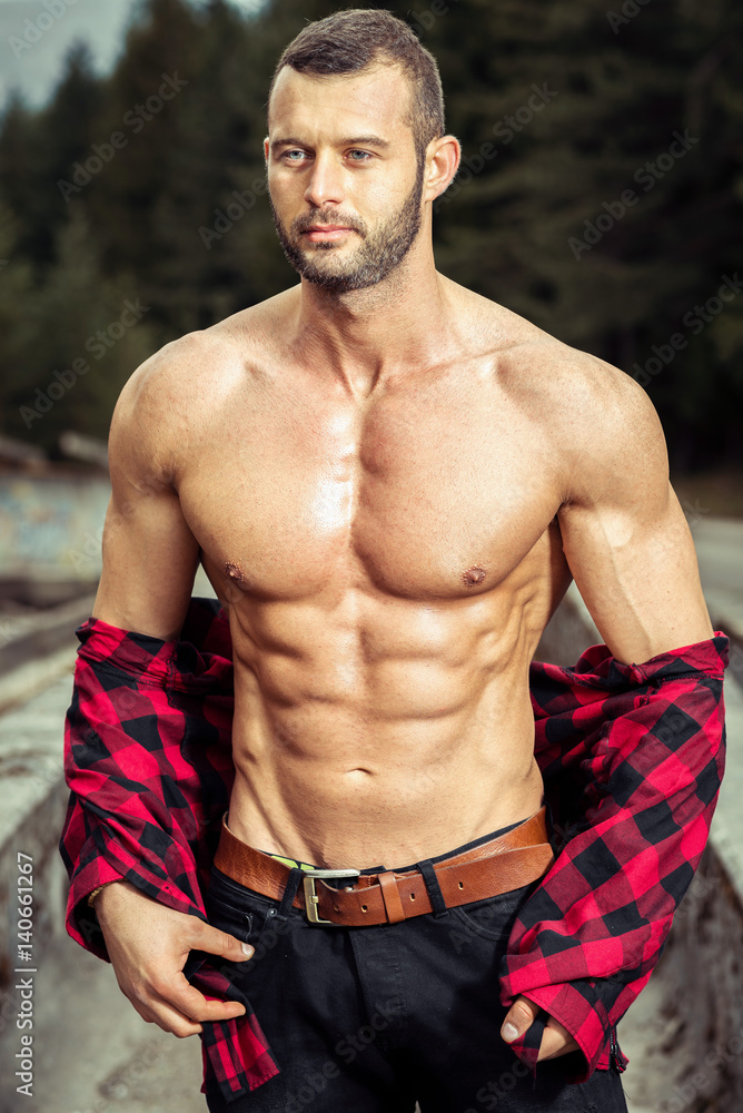 Fototapeta premium Handsome man wearing checked shirt outdoors
