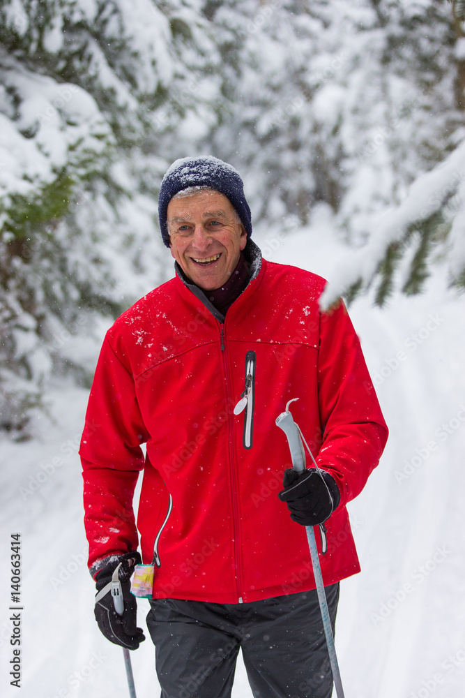 senior in winter on snow with skis cross-country skiing