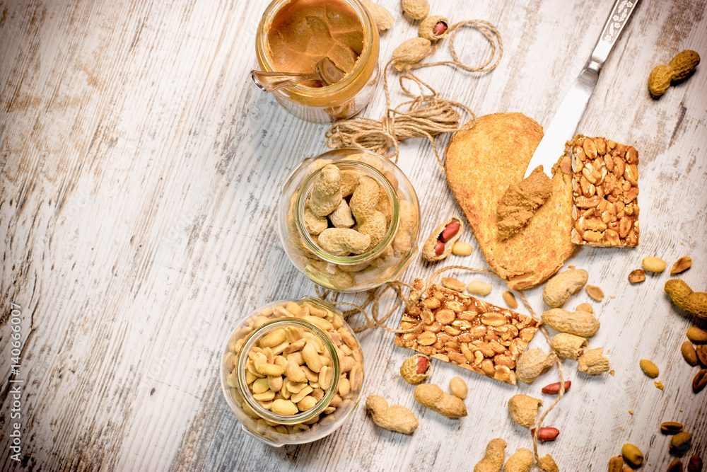 Organic peanut, peanuts in shell, peanut butter and sweet peanut chips (tiles) - delicious and healthy food Organic peanut, peanuts in shell, peanut butter and sweet peanut chips (tiles) - delicious and healthy food