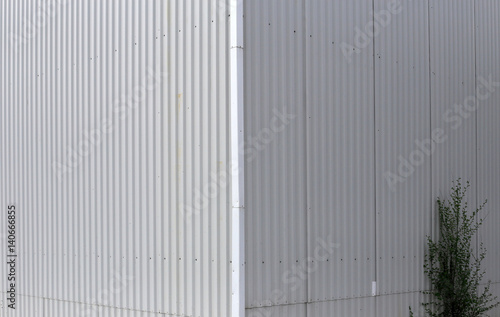 Beauty in the geometry of the structure of modern Wall of corrugated metal. Perspective up. Long thin lines. Elegant design.