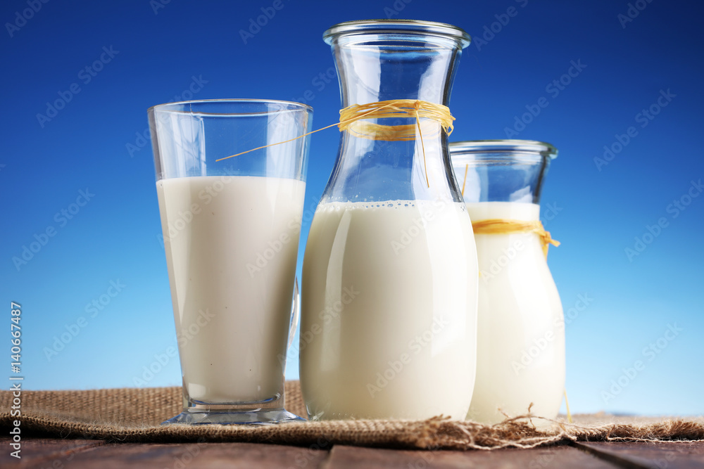 milk products - tasty healthy dairy products on a table on: and milk jar, glass bottle and in a glass milk products - tasty healthy dairy products on a table on: and milk jar, glass bottle and in a glass