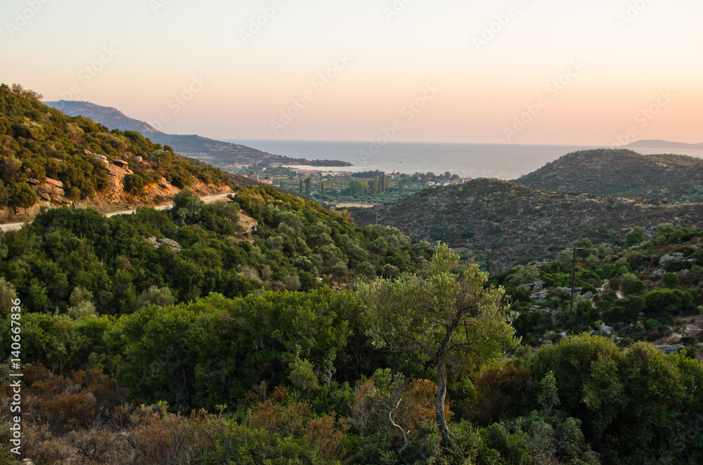 Panorama of a small greek village by the sea at sunset, Sithonia, Greece