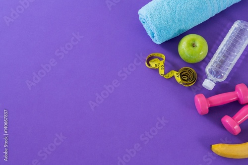 Dumbbell, apple, towel, water bottle and measuring tape