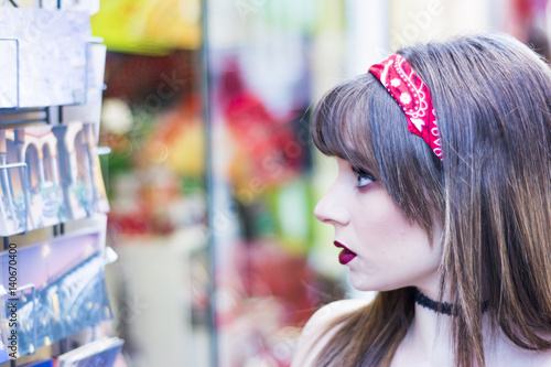 Portrait of a beautiful woman  in the street window shopping