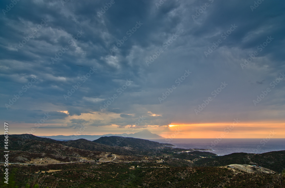 Stormy sky and sunrise at holy mountain Athos in Greece Stormy sky and sunrise at holy mountain Athos in Greece