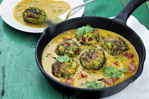 Courgette fritters in vegetable sauce 