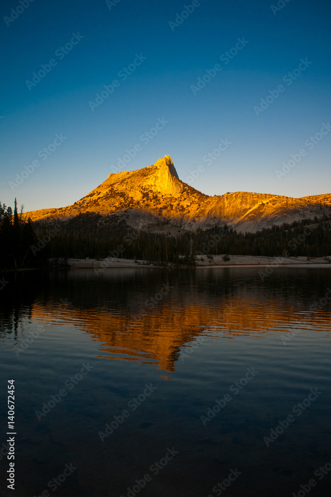 Alpine Glow on Cathedral Peak reflected in Lower Cathedral Lake in Yosemite National Park