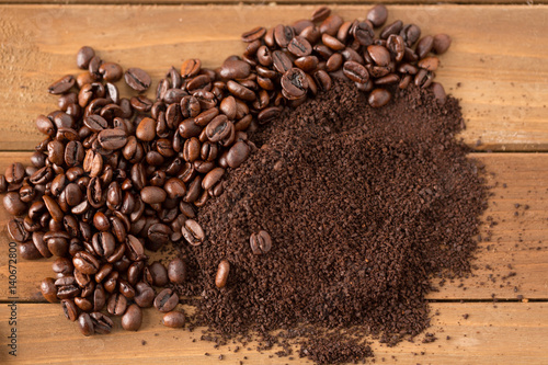 Pile of Coffee Beans and Grounds in Middle of Wood. pile of coffee beans and grounds from above split down the middle above photo