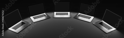 Five modern laptop in the dark 3D rendering