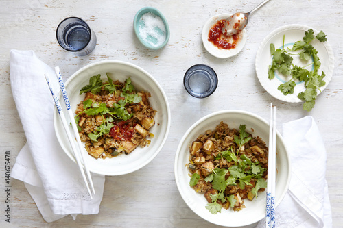 Tofu and zucchini fried rice with sambal in two bowls.