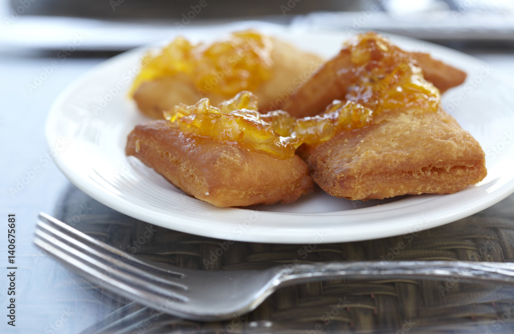 Johnny cakes with orange marmalade on a plate. Johnny cakes with orange marmalade on a plate.