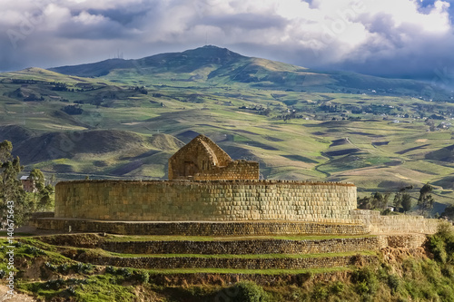 Scenic Inca ruins of Ingapirca and surrounding green andean landscape with dramatic sky, Ecuador photo