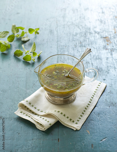 Homemade salad dressing with herb.