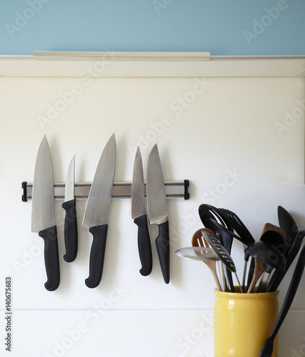 Knives on a magnetic strip in the kitchen.