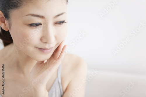 Woman touching her cheek photo