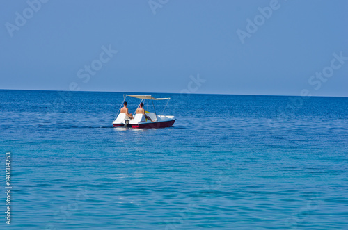 Couple driving a pedal boat on a vacation at Aegean sea somewhere in Greece © banepetkovic