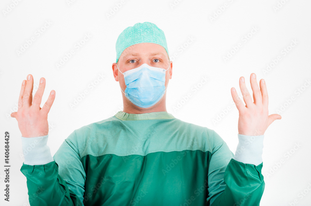 Surgeon wearing surgical mask and cap getting ready for surgery Surgeon wearing surgical mask and cap getting ready for surgery