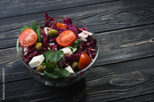 fresh salad in glass bowl with tomato