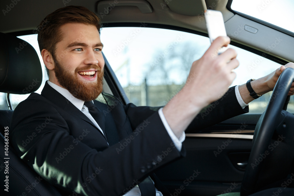 Side view of happy business man making selfie