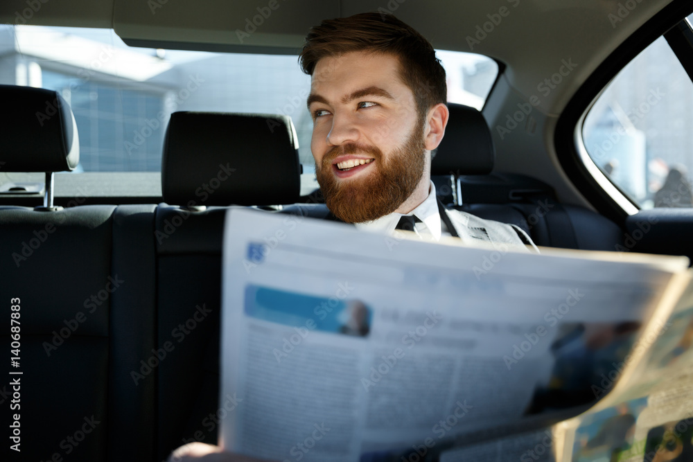 Happy bearded man sitting with newspaper Happy bearded man sitting with newspaper