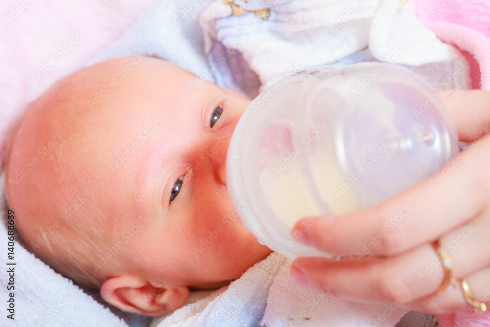 Little newborn eating drinking from bottle Little newborn eating drinking from bottle