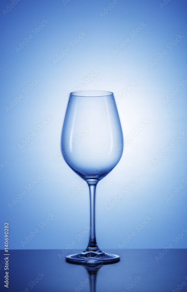 Fototapeta premium Wine glass on color background