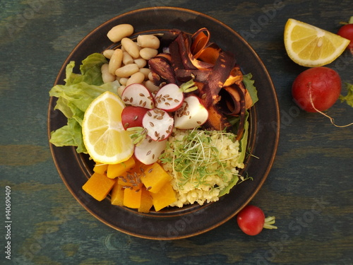 Bowl of Buddha. Vegetarian food, millet, beans and raw vegetables photo