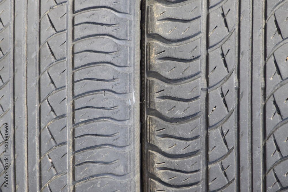 Fototapeta premium The background of the tread pattern of the car wheel. Rubber tir