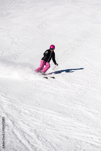 Female skier in fresh powder snow