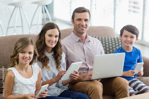 Smiling family using digital tablet, phone © WavebreakMediaMicro