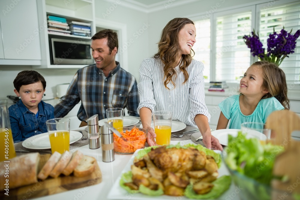 Smiling family having lunch together on dining table