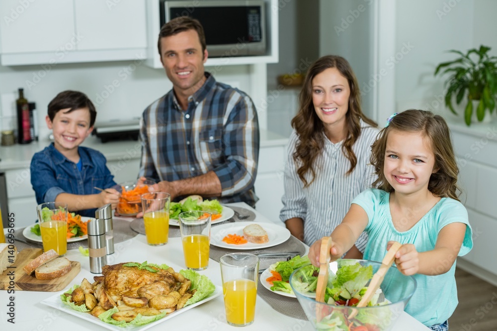 Portrait of smiling family having lunch together on dining table