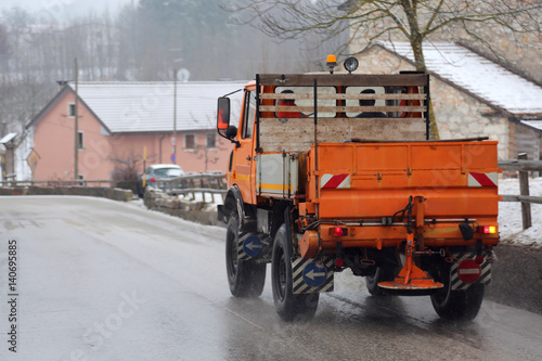 salt spreader on the road operating in winter