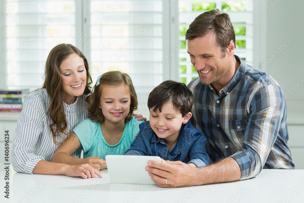 Family using digital tablet in living room at home Family using digital tablet in living room at home